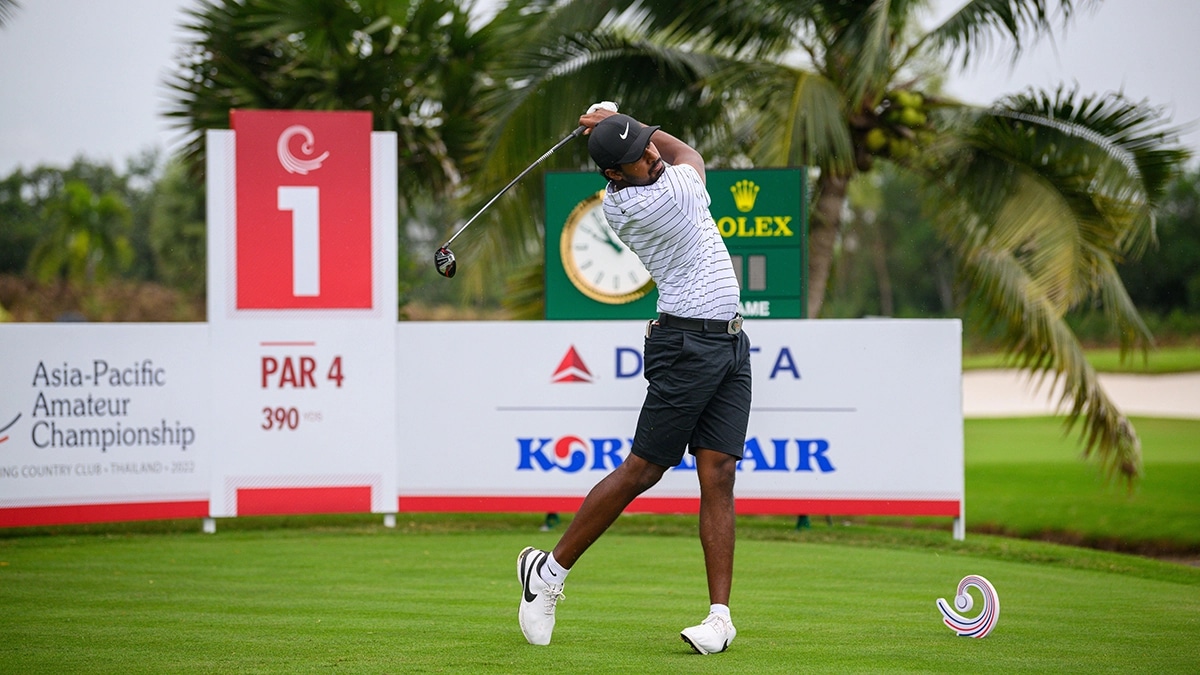 Golf course with player teeing off