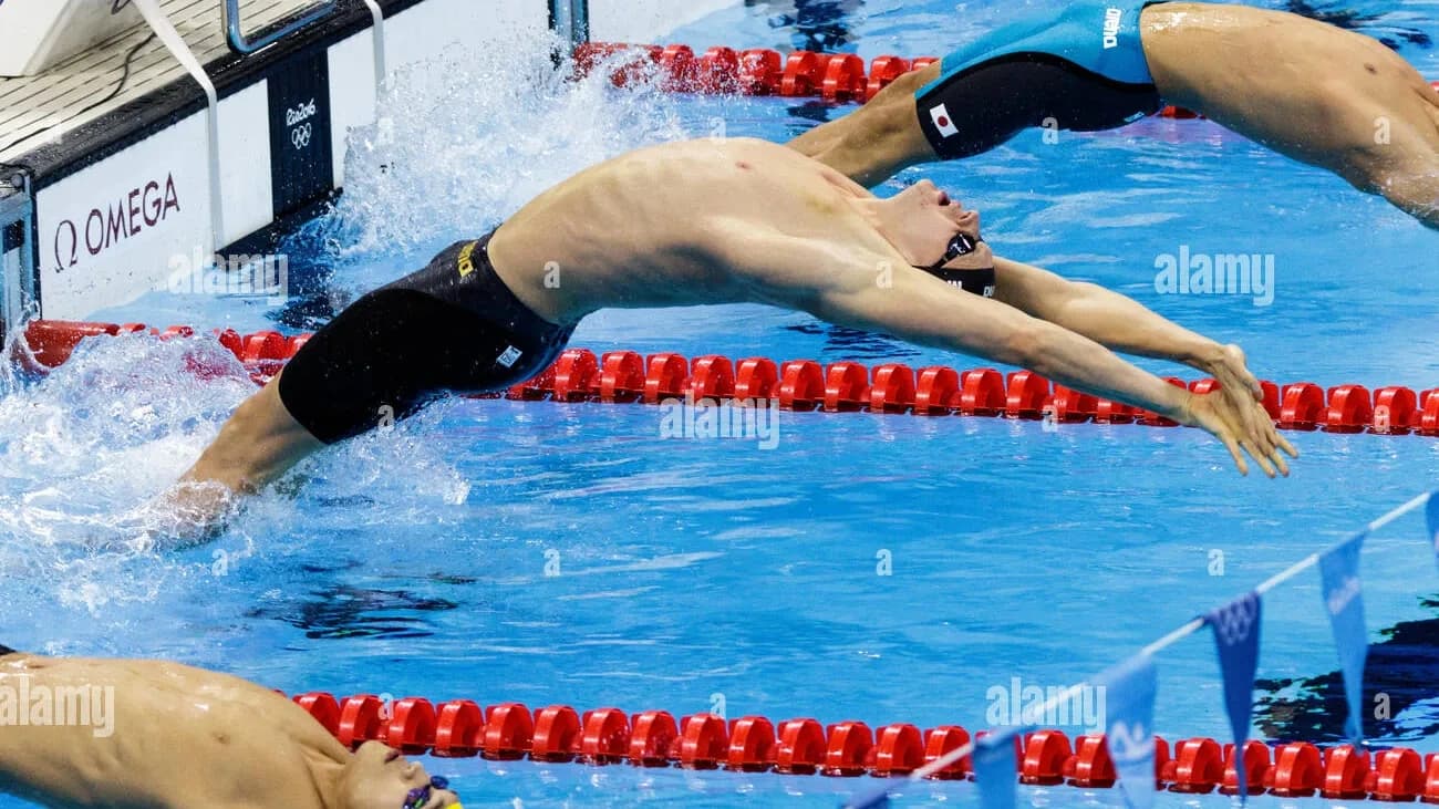 Olympic swimming pool during a championship final with poolside sports sponsorship branding - World Sports Advertising